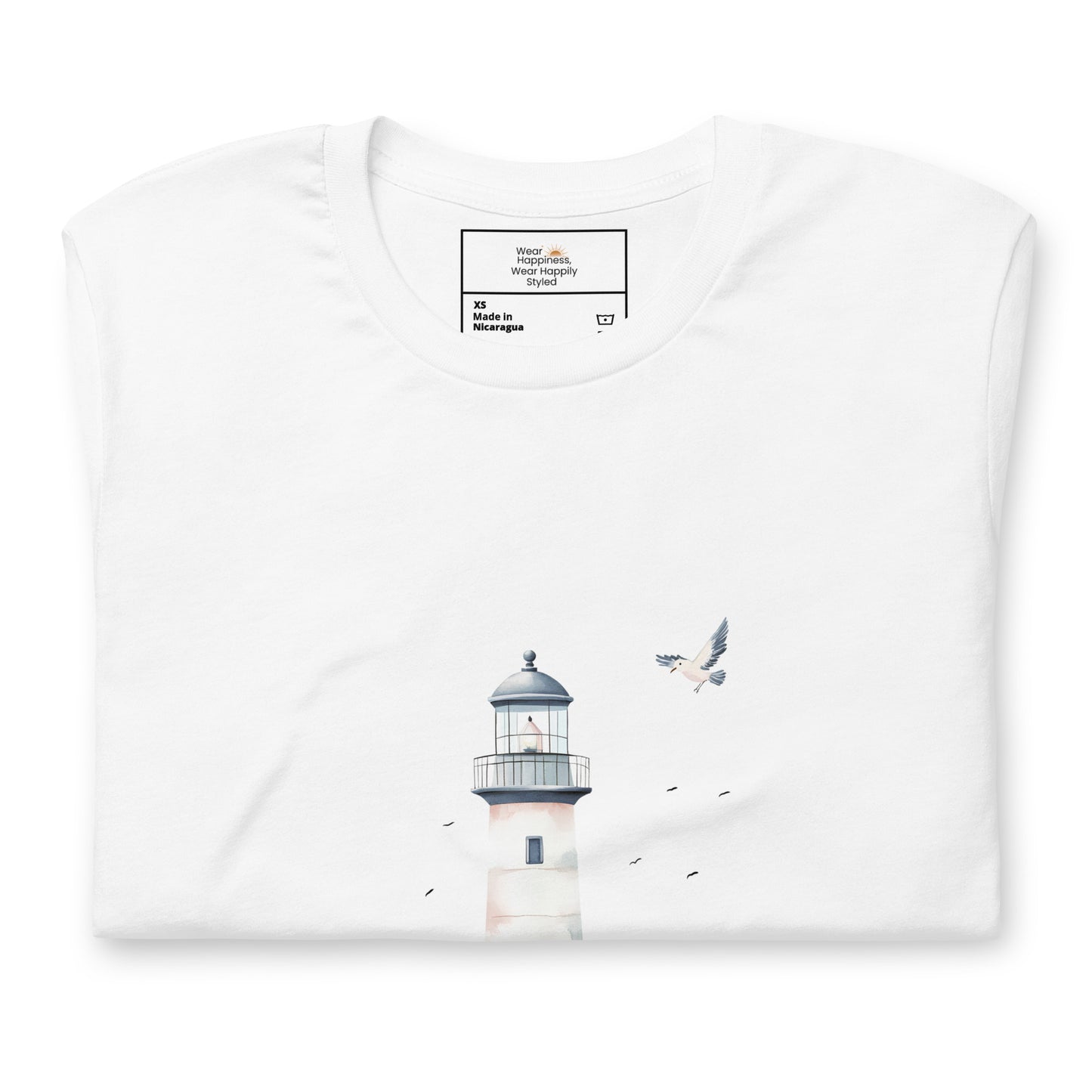 Flat-lay of a folded white t-shirt featuring a minimal lighthouse and seagull design, styled for a calming, nature-inspired mom aesthetic.