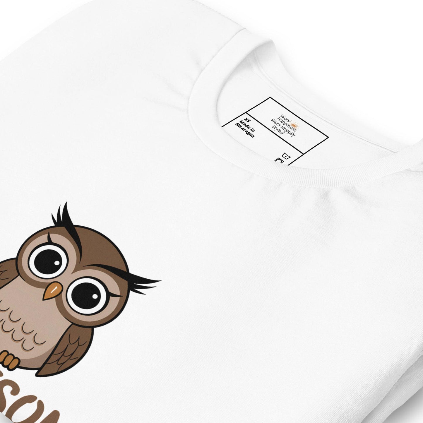 Close-up of a white t-shirt with a cute cartoon owl graphic peeking from the bottom