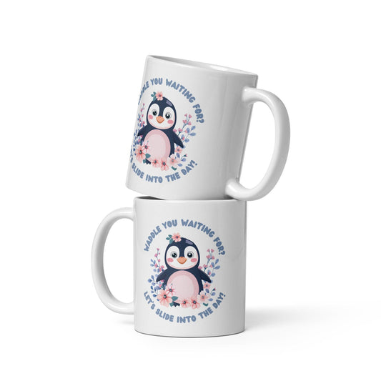 Two stacked white mugs featuring a cute penguin illustration with the text “Waddle You Waiting For? Let’s Slide Into the Day!” surrounded by pink and blue flowers, displayed on a white background.