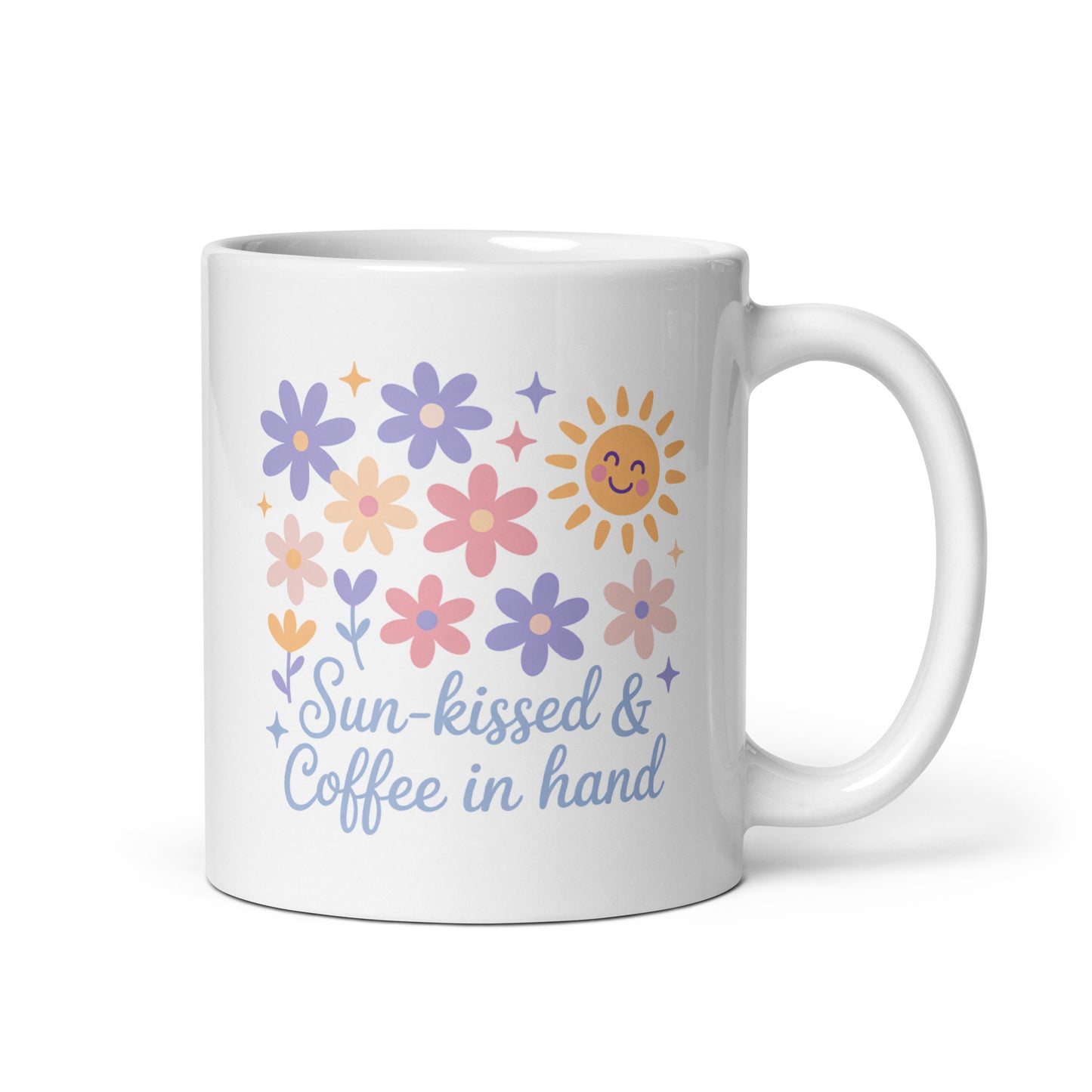White ceramic mug with pastel flowers, smiling sun, and “Sun-kissed & Coffee in Hand” text – summer coffee mug for moms by Happily Styled