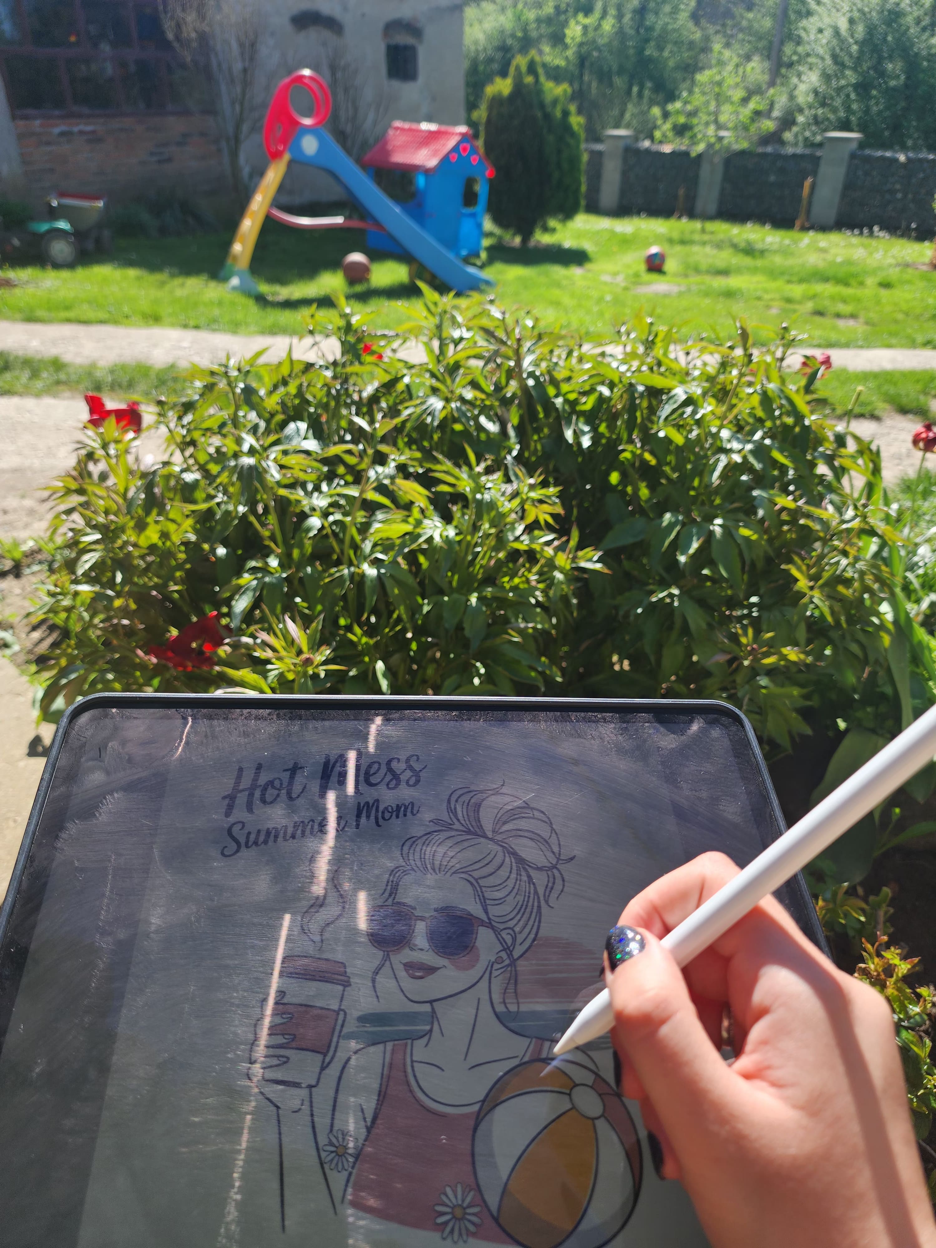 picture of hand drawing on ipad in the yard