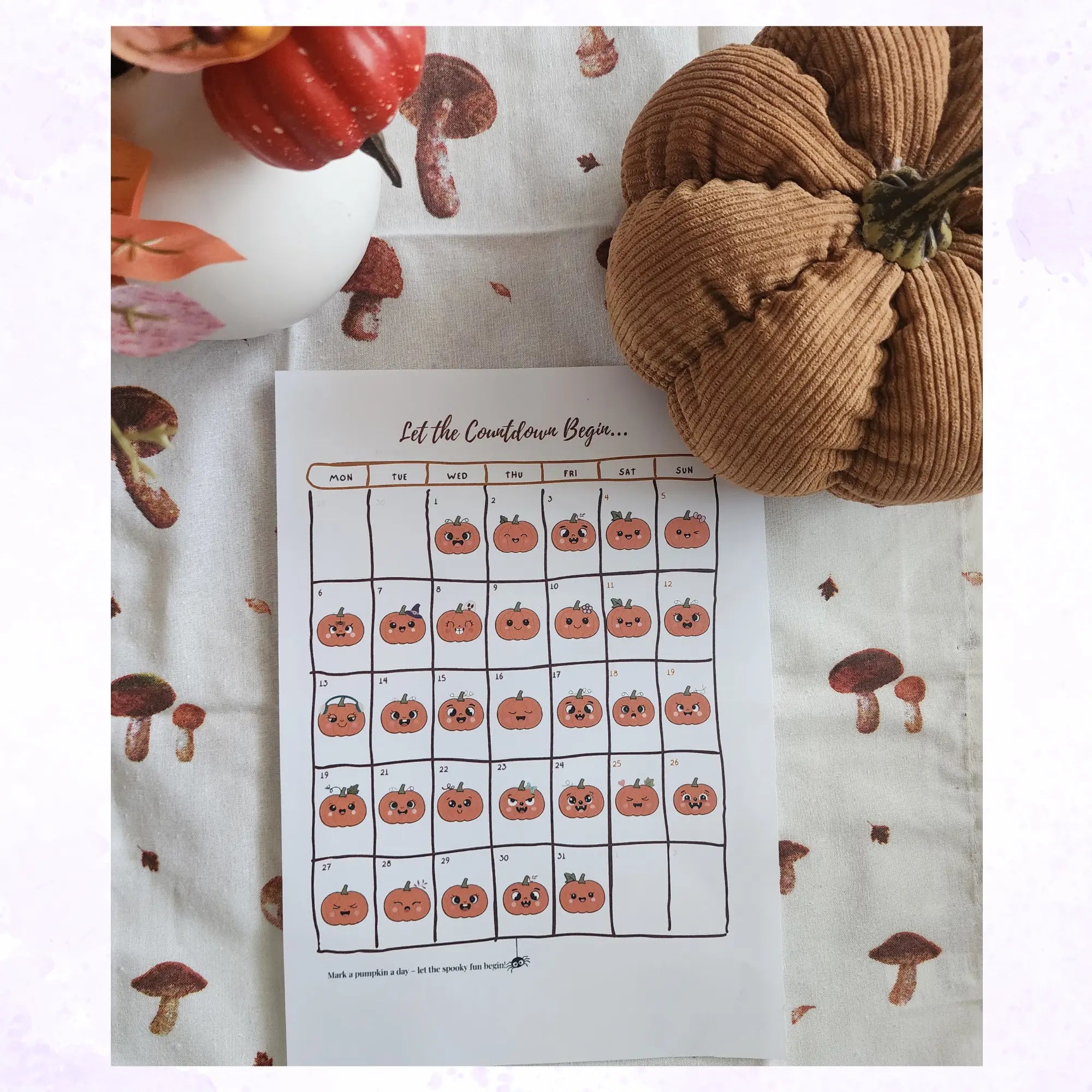 Countdown calendar with pumpkins on a fabric background with pumpkins and mushrooms.