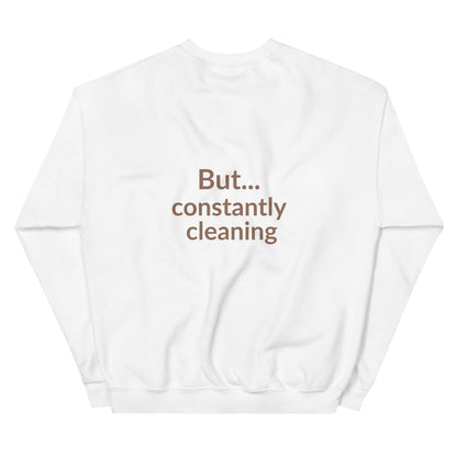 White sweatshirt with text 'But... constantly cleaning' on a white background