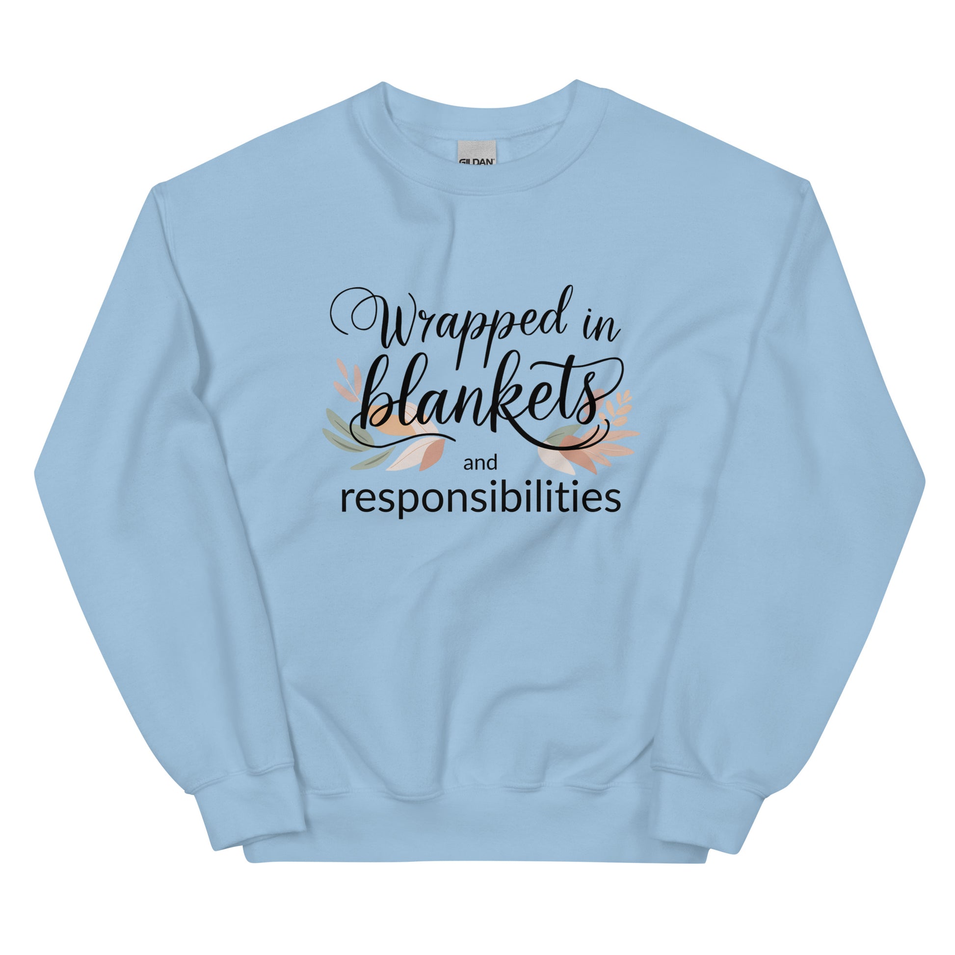 Light blue sweatshirt with text 'Wrapped in blankets and responsibilities' on a white background