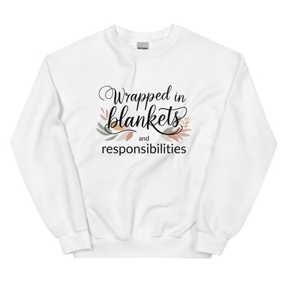 White sweatshirt with text 'Wrapped in blankets and responsibilities' on a white background