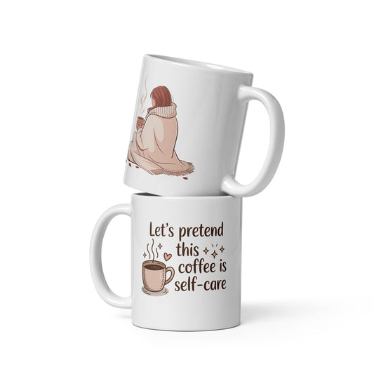 Two stacked white mugs on a white background. One mug shows a cozy autumn illustration of a woman wrapped in a blanket holding coffee. The other features the quote “Let’s pretend this coffee is self-care” with a cute cup, sparkles, and heart details.