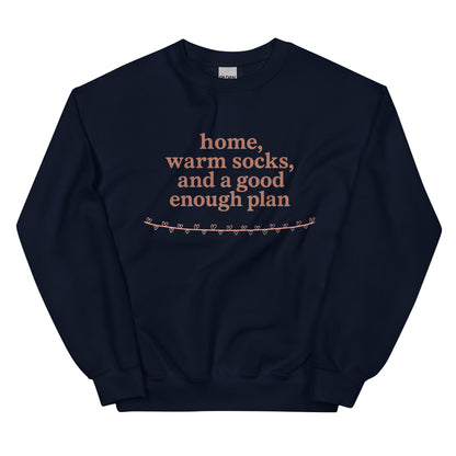 Navy blue sweatshirt with text 'home, warm socks, and a good enough plan' on a white background
