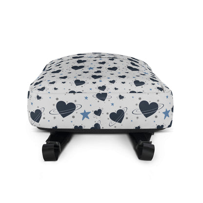 White backpack with all-over navy heart and star pattern, front pocket and visible inside pocket label - bottom