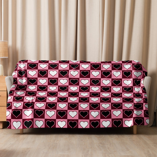Large heart print sherpa blanket spread across sofa backrest