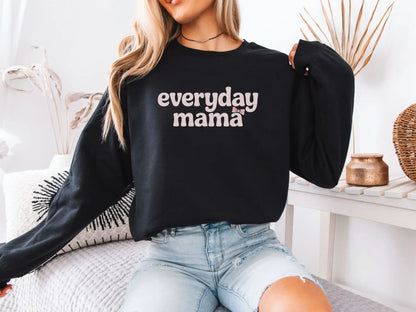 Model wearing black Everyday Mama sweatshirt with pink bow graphic