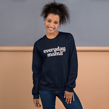 Woman wearing a navy sweatshirt with 'everyday mama' text against a neutral background