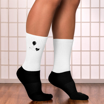 Heart and balloon socks on model – right side view showing playful black and white design