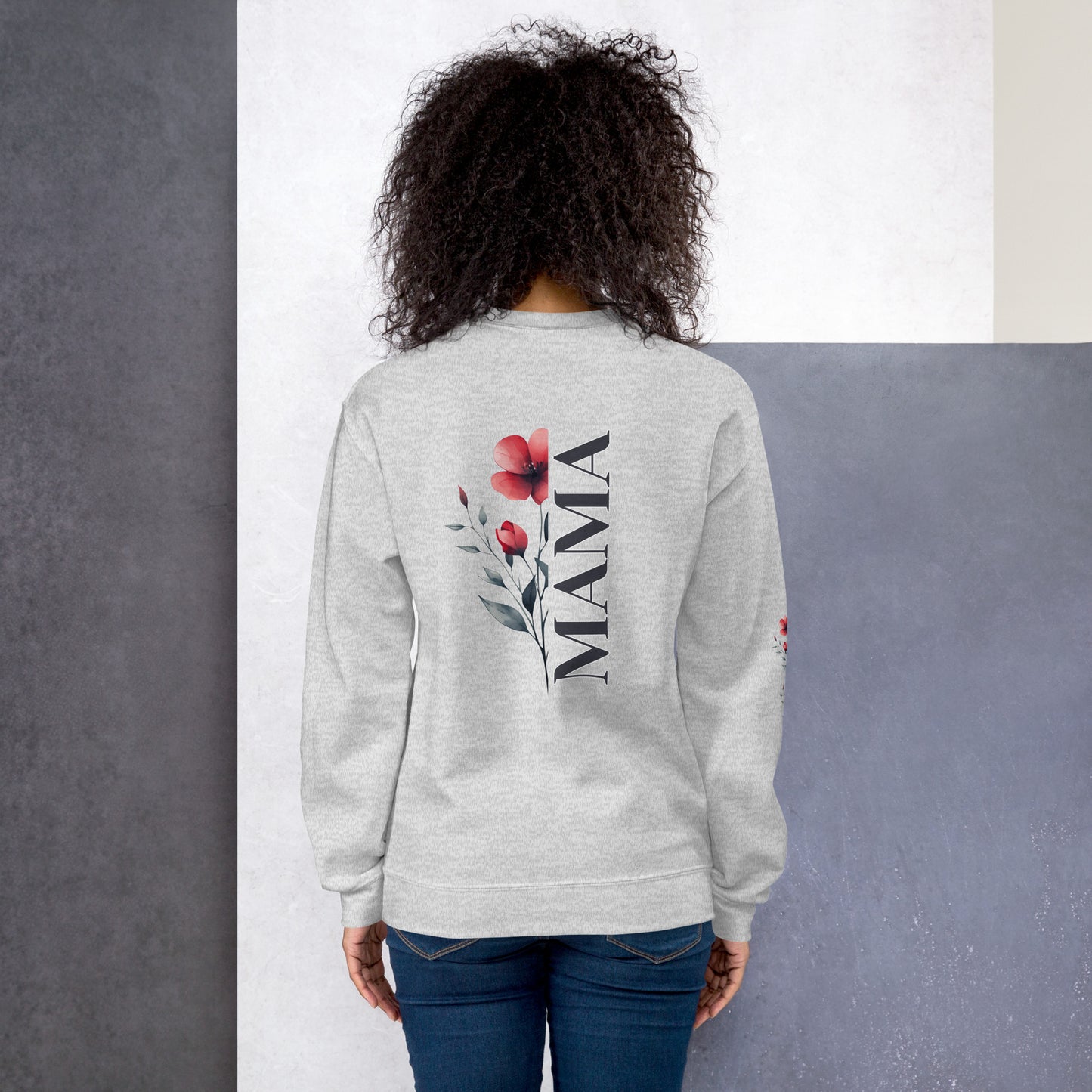 Smiling woman wearing ash sweatshirt with floral design detail on the sleeve - back view