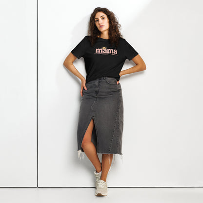 Woman wearing black ‘mama’ t-shirt with pastel sun design, styled with denim skirt, standing against white wall
