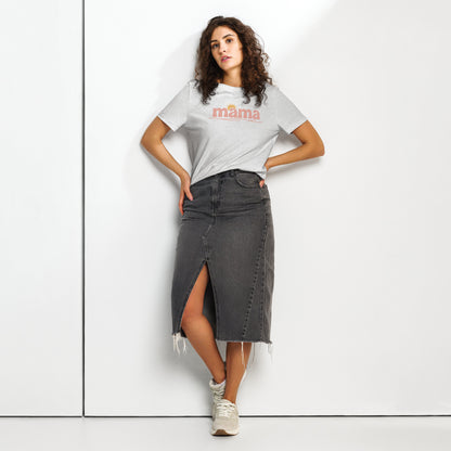Woman wearing grey ‘mama’ t-shirt with pastel sun design, styled with denim skirt, standing against white wall