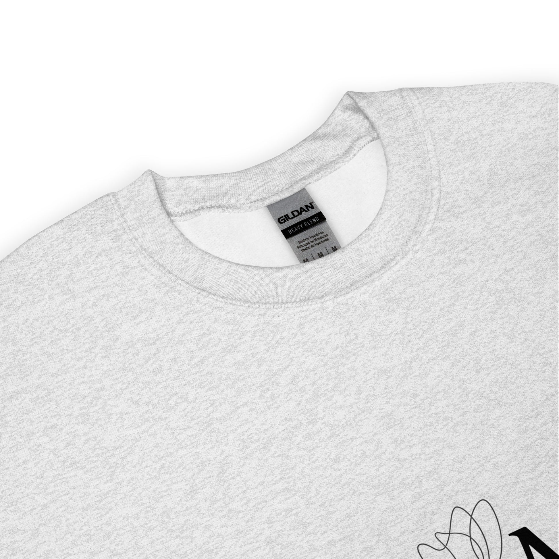 Close-up of ash gray MAMA sweatshirt showing Gildan label and floral design detail 