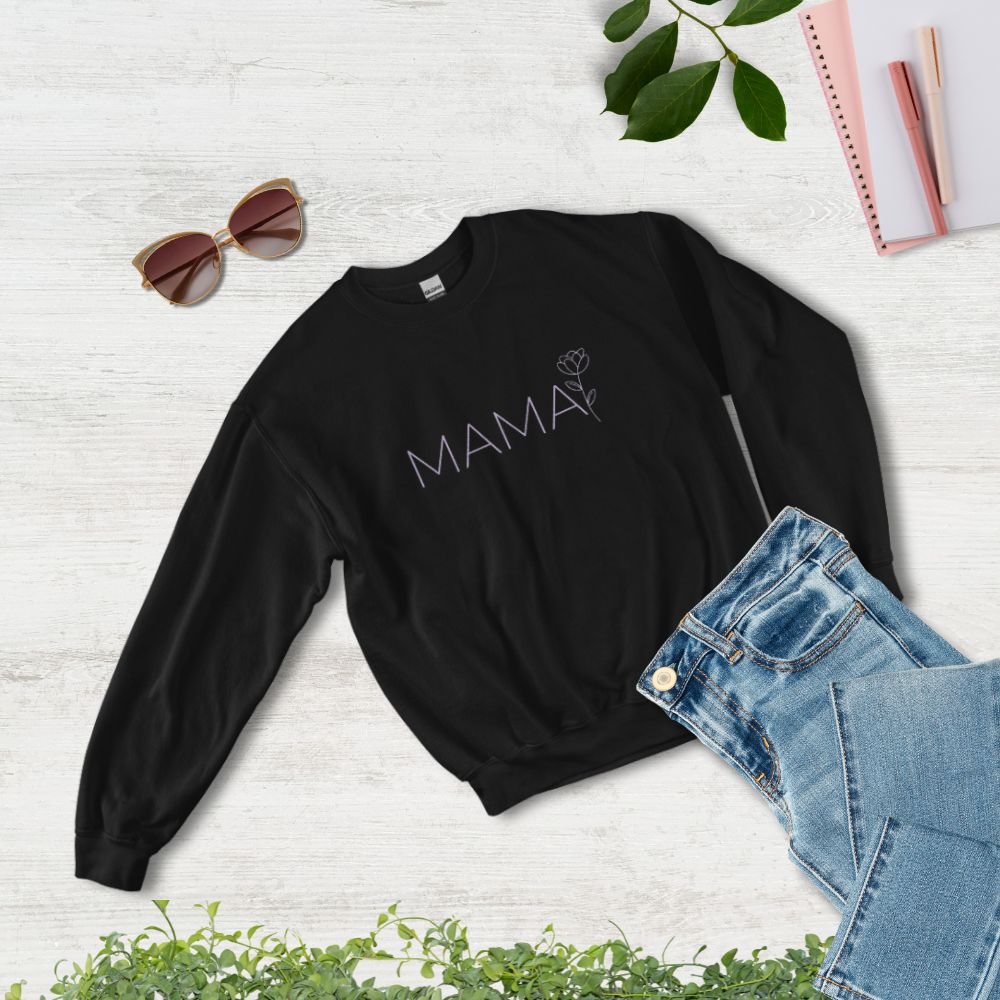 Flat lay of MAMA black sweatshirt styled with jeans, sunglasses, and notebook – cozy and chic gift for moms