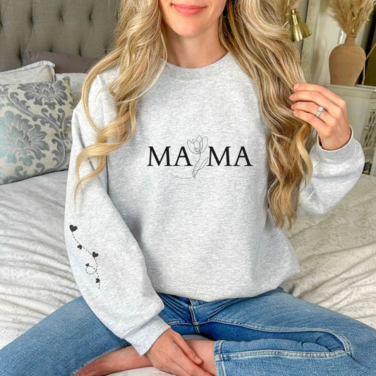 Woman wearing ash gray "MAMA" sweatshirt with floral design and heart balloon sleeve print