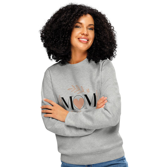 Smiling woman with arms crossed wearing heather grey sweatshirt with 'MOM' heart and floral design