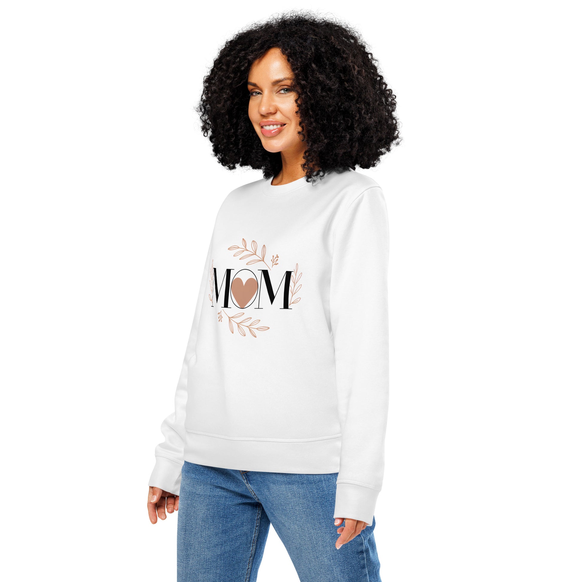 Smiling woman wearing white sweatshirt with 'MOM' and heart design surrounded by floral accents