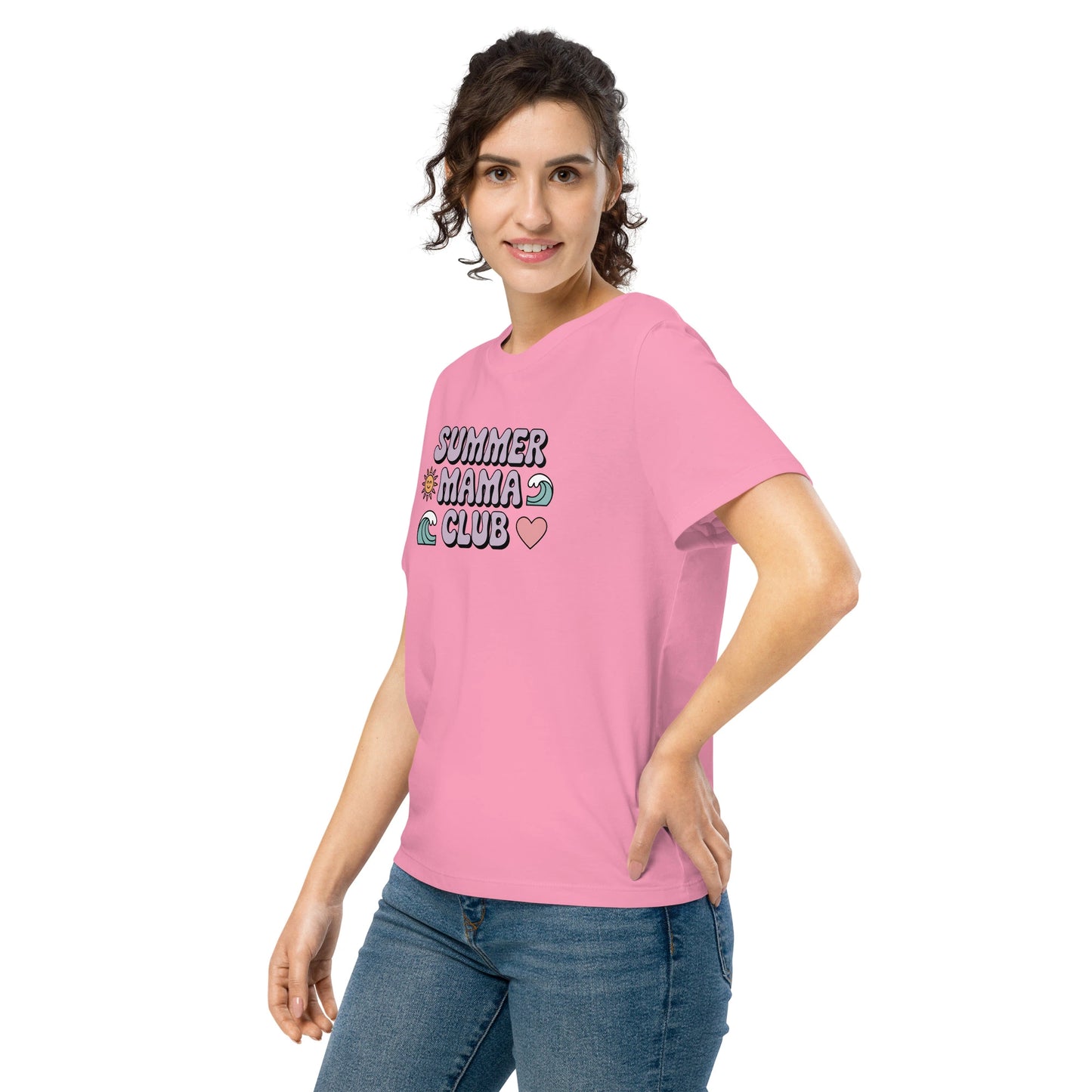 Woman modeling a pastel pink “Summer Mama Club” t-shirt with cute wave, sun, and heart graphics in a playful summer vibe.