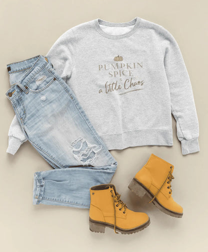 Gray sweatshirt with 'Pumpkin Spice and a Little Chaos' text, light blue jeans, and yellow boots on a beige background