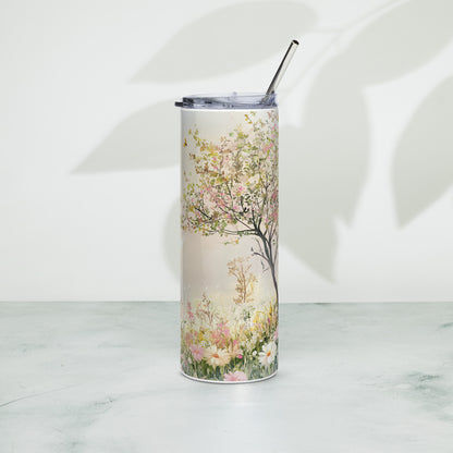 Stainless steel tumbler with pastel floral tree design, placed on a light surface with soft leaf shadows in the background.