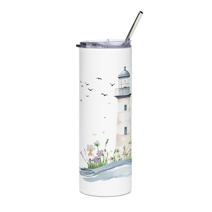 White stainless steel tumbler with a pastel lighthouse illustration, soft waves, and wildflowers, placed on a light surface