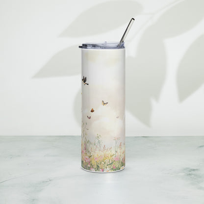 Tall pastel tumbler with floral meadow and butterflies, standing on a light surface with soft plant shadows in the background.
