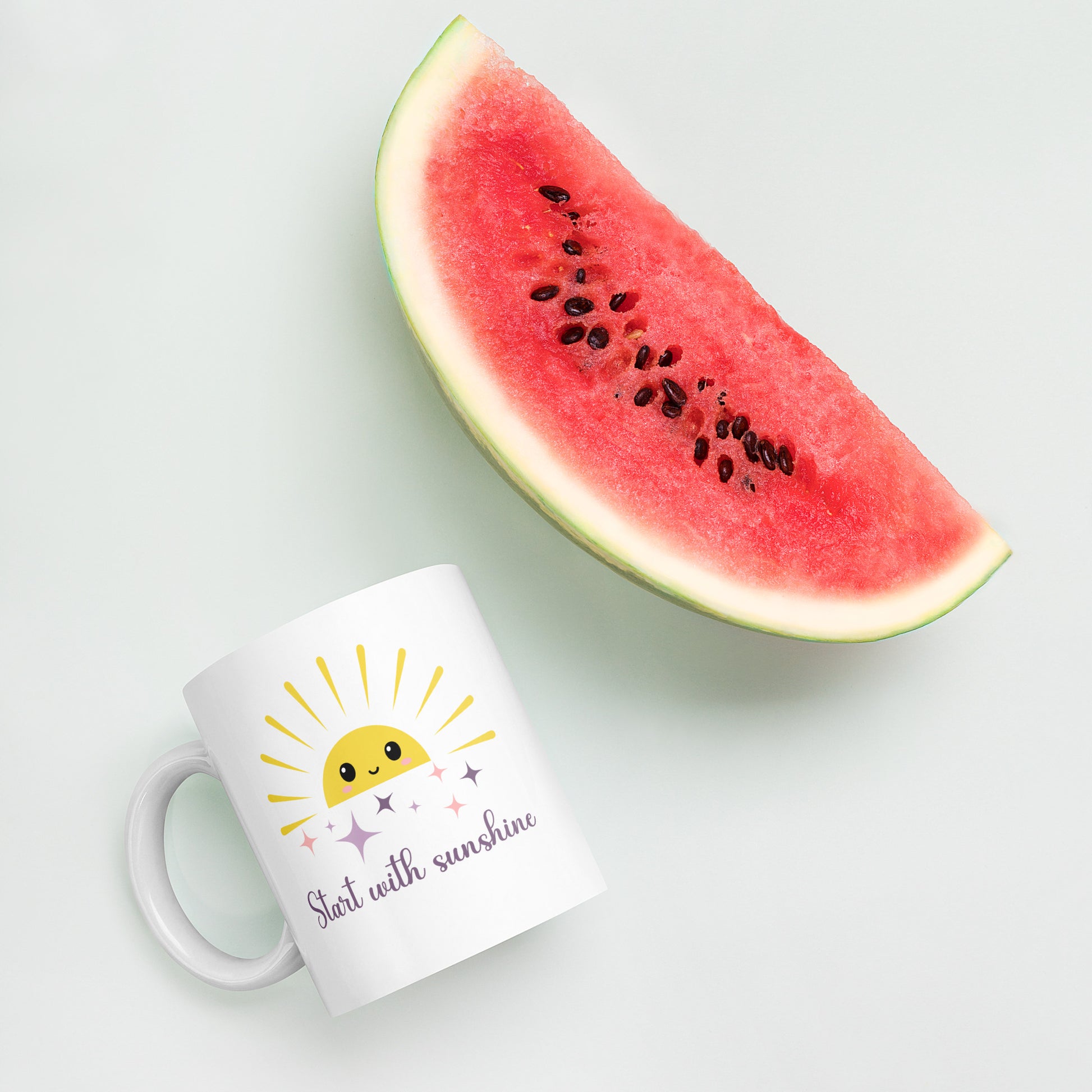 White coffee mug with smiling sun and sparkles, placed next to a fresh watermelon on pastel background — tropical summer flat lay with cozy morning vibes.