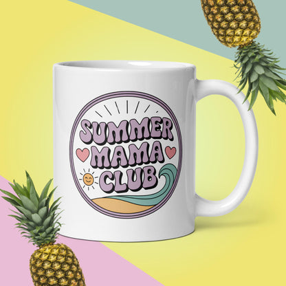 White 11oz ceramic mug with Summer Mama Club design, surrounded by pineapples on pastel beachy background