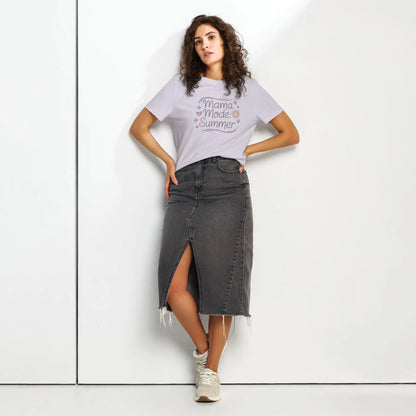 Model wearing lavander 'Mama Mode: Summer' t-shirt paired with a dark denim skirt, standing against a white background.
