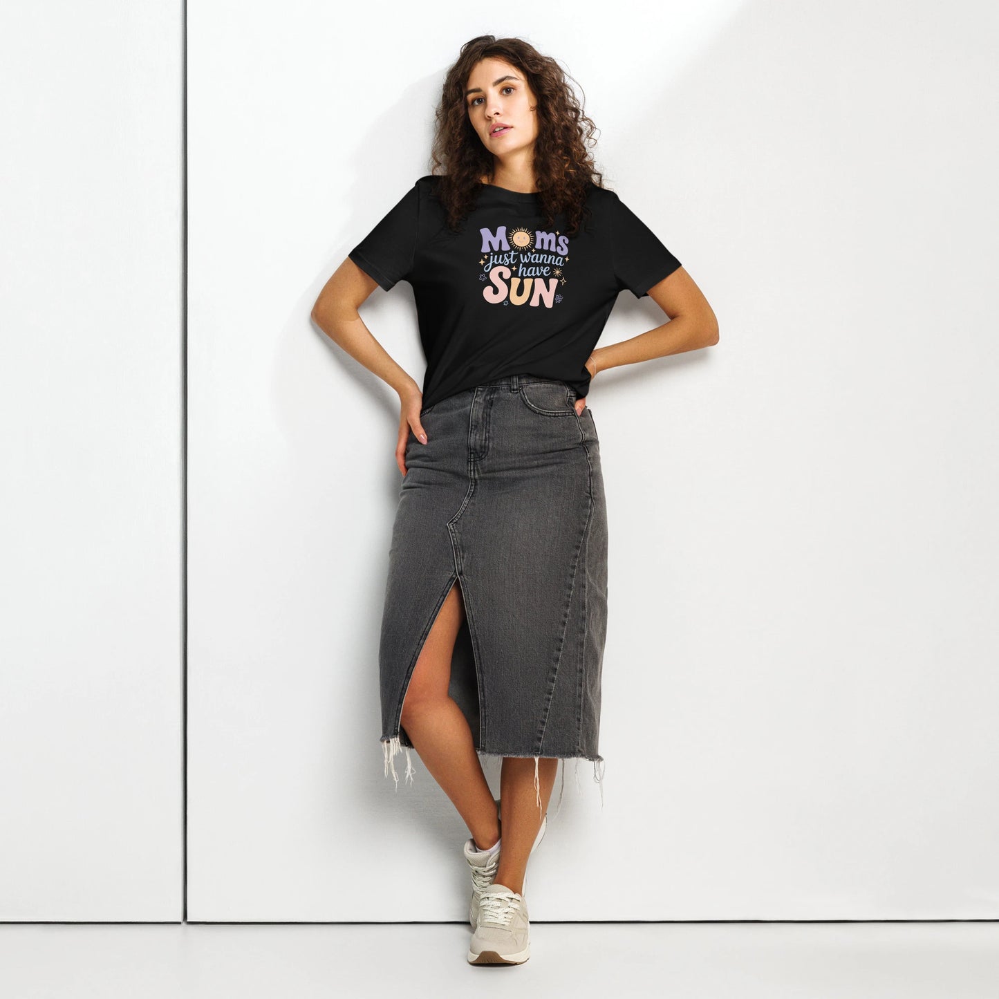 Woman wearing a black t-shirt with “Moms Just Wanna Have Sun” design in pastel colors – styled summer t-shirt for moms