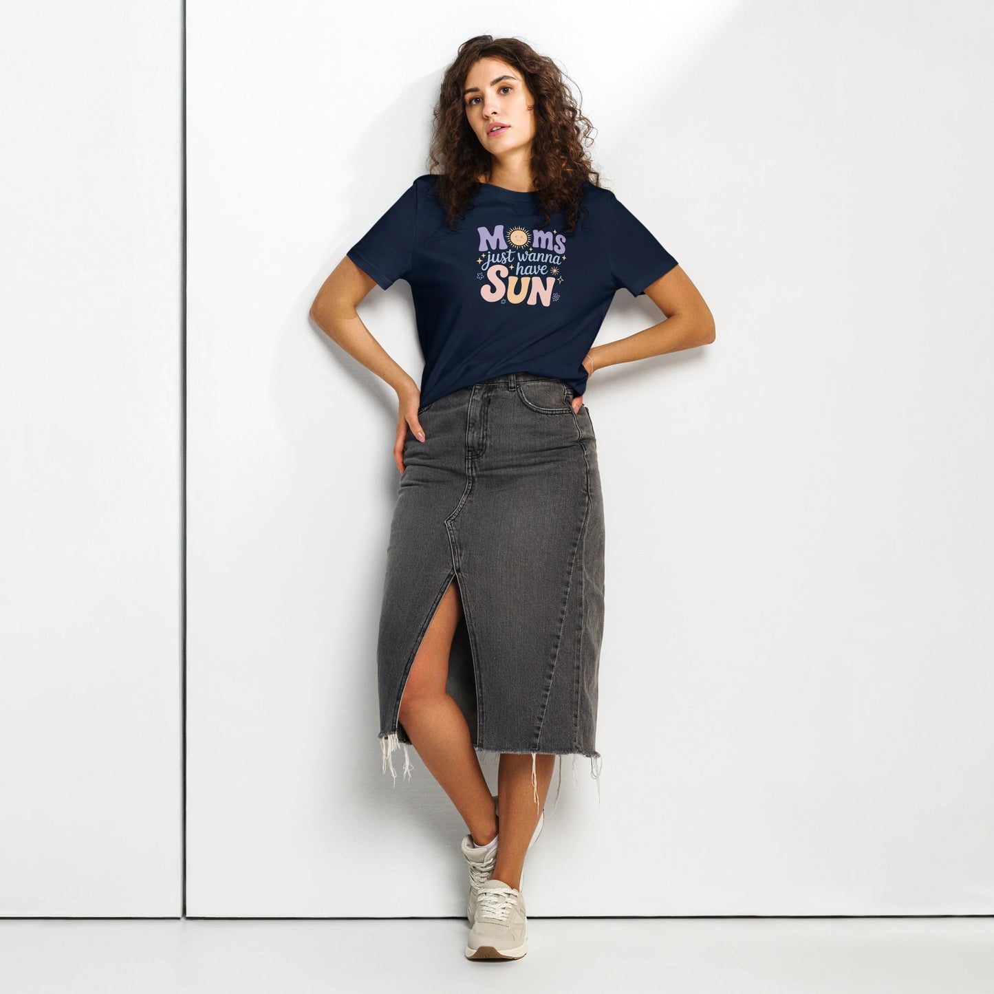 Woman wearing a navy blue t-shirt with “Moms Just Wanna Have Sun” design in pastel colors – styled summer t-shirt for moms