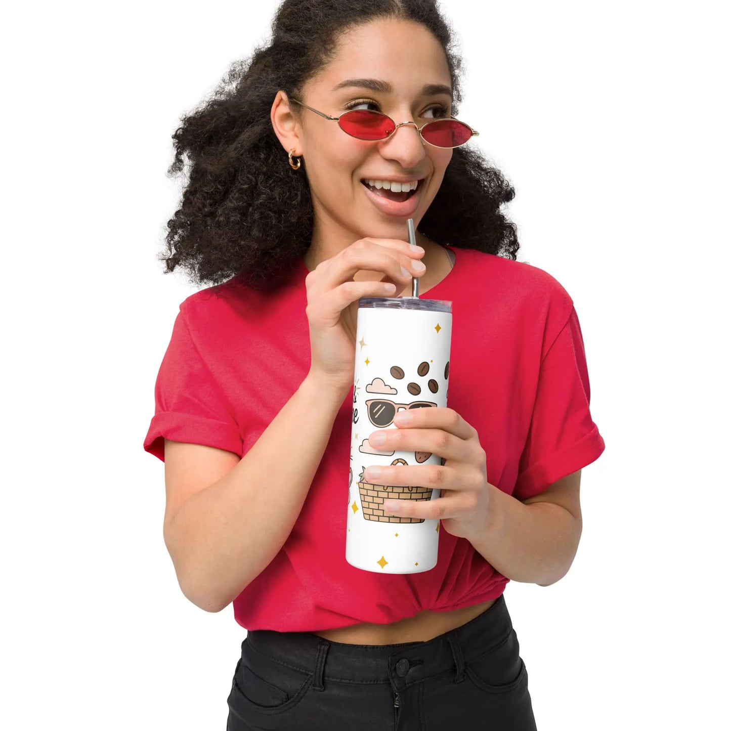 Front view of smiling woman holding a summer-themed stainless steel tumbler featuring sunglasses, picnic basket, and pastel coffee illustrations.