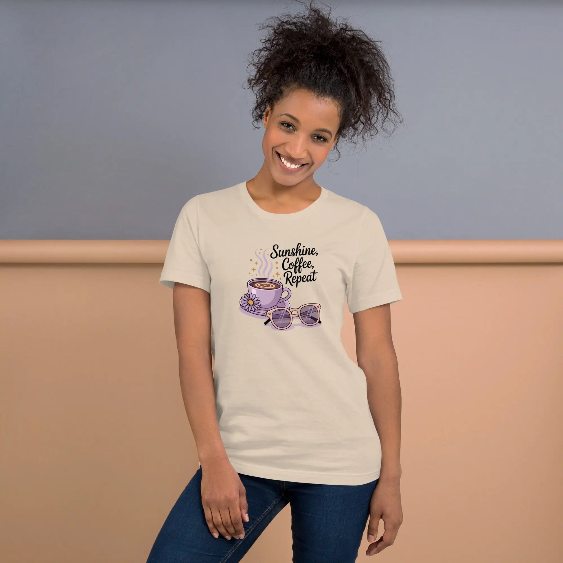  Smiling woman wearing a cream summer t-shirt with cute coffee cup, daisy flower, sunglasses and "Sunshine, Coffee, Repeat" quote.