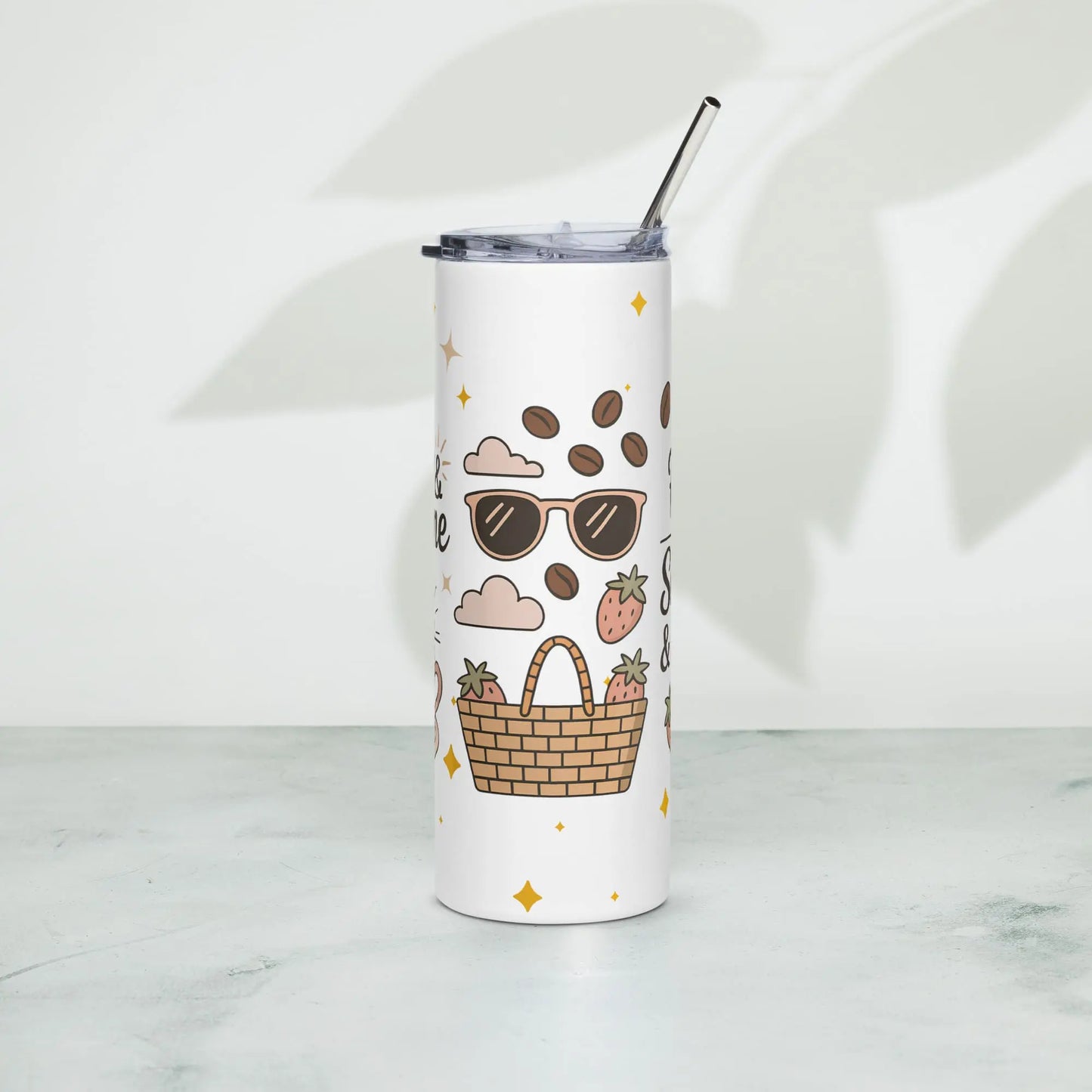 Front view of white stainless steel tumbler standing on marble surface, featuring a summer picnic-themed design with sunglasses, coffee beans, and basket.