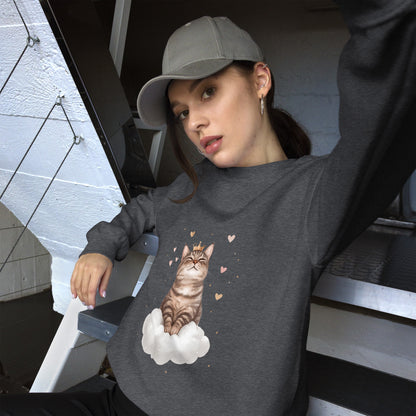 Woman wearing a dark heather sweatshirt with a realistic cat sitting on a white cloud, surrounded by floating hearts. She is sitting casually on stairs, wearing a gray cap and looking relaxed