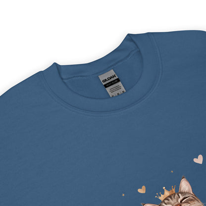 Close-up of a indigo blue sweatshirt collar with Gildan label visible and part of a cat graphic wearing a crown with tiny hearts.