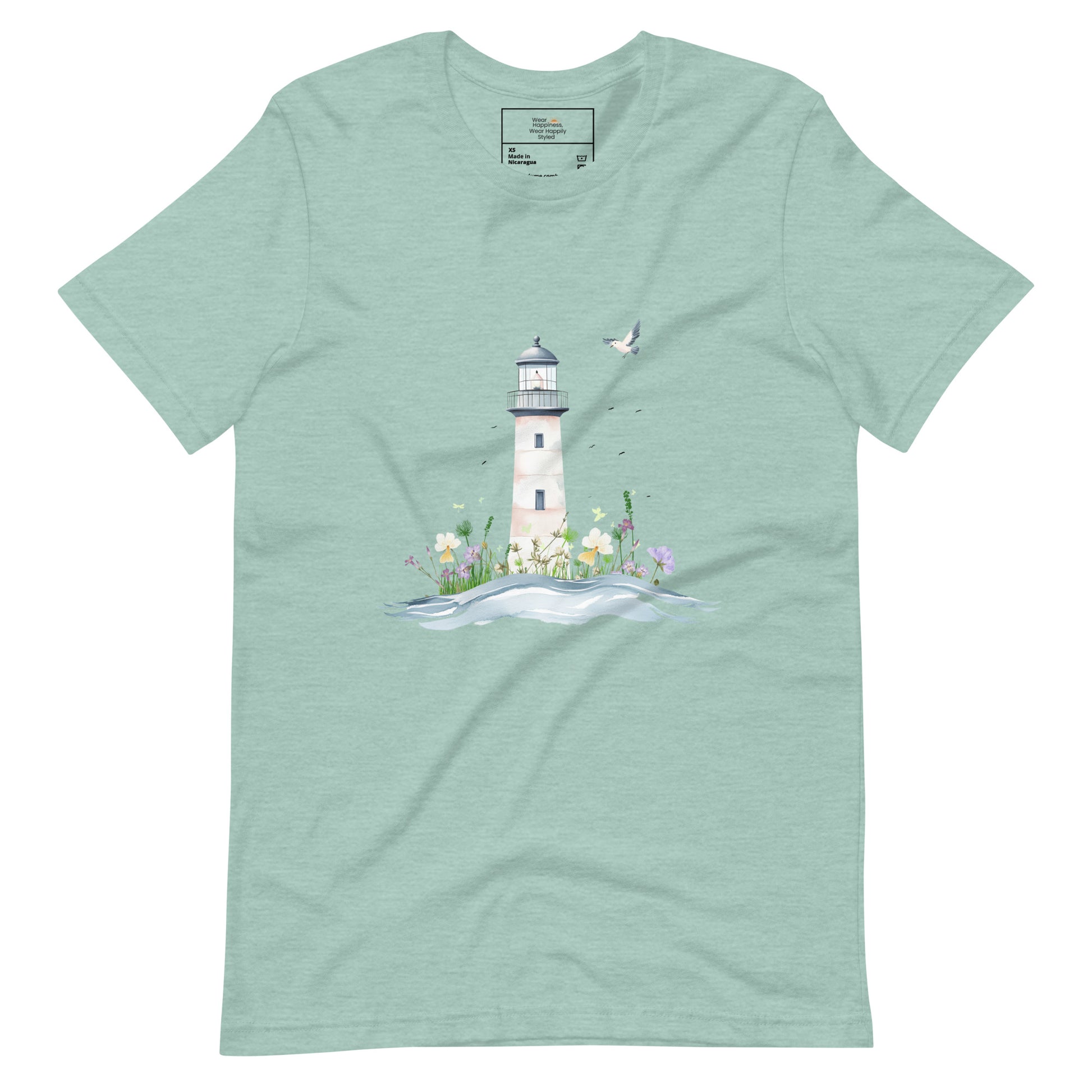 Dusty blue-colored t-shirt laid flat featuring a serene lighthouse illustration with floral details and a seagull in flight, designed for peaceful mom style.