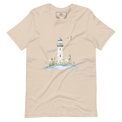 Soft cream-colored t-shirt laid flat featuring a serene lighthouse illustration with floral details and a seagull in flight, designed for peaceful mom style.