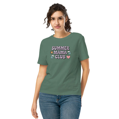 Woman wearing a green "Summer Mama Club" t-shirt with pastel design, standing in front of a white background.
