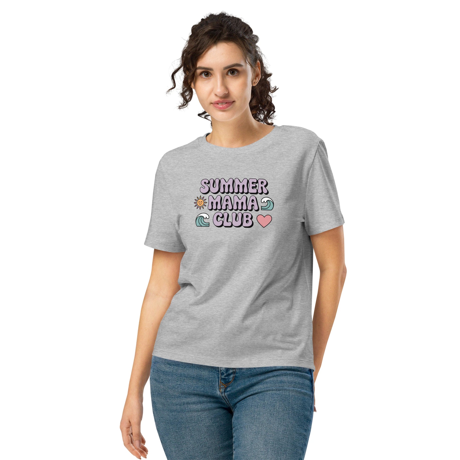 Woman wearing a heather grey "Summer Mama Club" t-shirt with pastel design, standing in front of a white background.