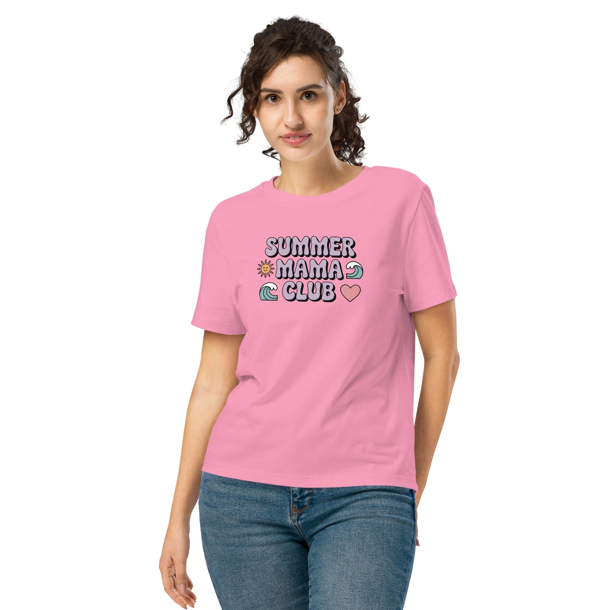 Woman wearing a pink "Summer Mama Club" t-shirt with pastel design, standing in front of a white background.