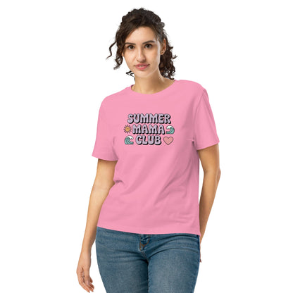 Woman wearing a pink "Summer Mama Club" t-shirt with pastel design, standing in front of a white background.